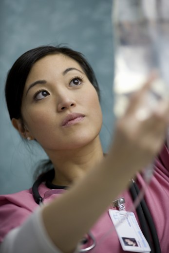 Close-up of a female doctor holding an IV drip bottle